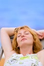 Woman rest in chaise on sea beach