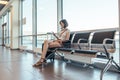 Woman resting in arrival hall waiting for a transfer at airport Royalty Free Stock Photo