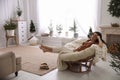 Woman resting in comfortable papasan chair at home