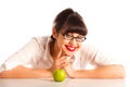 Woman resting on desk in glasses with apple Royalty Free Stock Photo