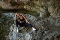 Woman resting after exhausting workout. Sport outdoors. Morning running. Healthy active concept. Mountain on background