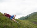 Woman resting on a glade with flowers