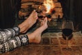 Woman resting with glass of red wine near fireplace Royalty Free Stock Photo