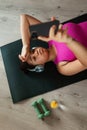 Woman resting after home workout, New Year& x27;s resolutions, healthy lifestyle, losing weight and selfcare. Concept of
