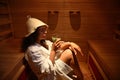 Woman resting in infrared sauna. SPA resort treatment. Beauty therapy concepts