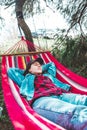 woman resting laying down in hammock between trees Royalty Free Stock Photo