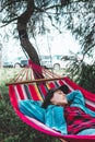 woman resting laying down in hammock between trees Royalty Free Stock Photo