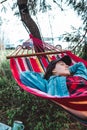 woman resting laying down in hammock between trees Royalty Free Stock Photo