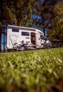 Woman resting near motorhomes in nature. Family vacation travel, holiday trip in motorhome RV, Caravan car Vacation. Royalty Free Stock Photo