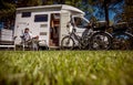 Woman resting near motorhomes in nature. Family vacation travel, holiday trip in motorhome RV, Caravan car Vacation. Royalty Free Stock Photo