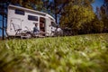 Woman resting near motorhomes in nature. Family vacation travel, holiday trip in motorhome RV, Caravan car Vacation. Royalty Free Stock Photo