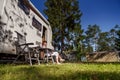 Woman resting near motorhomes in nature. Family vacation travel, holiday trip in motorhome RV, Caravan car Vacation. Royalty Free Stock Photo