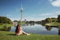 Woman resting in Olympiapark, Munich. Brunette sitting on the gr