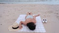 Woman is resting at the sea and defended from insects