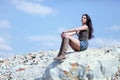 Woman resting on stone boulder