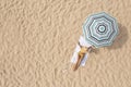 Woman resting under striped beach umbrella at sandy coast, aerial view. Space for text Royalty Free Stock Photo