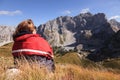 Woman resting and watching the mountain peaks