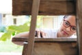 A woman restores and improves an old wooden chair in her home