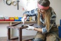 woman painting and restoring furniture