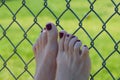 Woman rests feet on fence