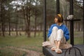 Woman rests near wooden cottage in nature Royalty Free Stock Photo