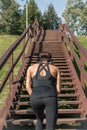 Woman rests by stairs