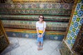 Woman rests while visiting King Palace in Bangkok, Thailand