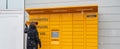 Woman retrieving parcel from Amazon locker