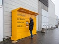 Woman retrieving parcel from Amazon locker