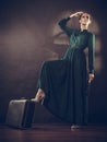 Woman retro style with old suitcase and fan Royalty Free Stock Photo