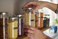Woman Reusing Glass Jars To Store Dried Food Living Sustainable Lifestyle At Home