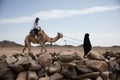 Woman ride in camel desert location