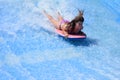 Woman ride a surfing board on FlowRider