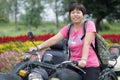 Woman ride three wheeled motorcycle, adobe rgb