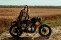 Woman rider with his vintage custom made cafe racer Royalty Free Stock Photo