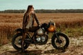 Woman rider with his vintage custom made cafe racer Royalty Free Stock Photo