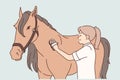 Woman rider takes care of thoroughbred horse by combing animal mane before important races