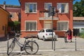 Woman rides bicycle in Rimini, Italy.