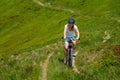 Woman rides bicycle up in the mountains Royalty Free Stock Photo