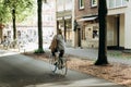 A woman rides a bike along a cycle path. Everyday city life.