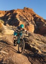 A woman rides a mountain bike down the Jem trail below Gooseberry mesa in the Southern Utah desert Royalty Free Stock Photo