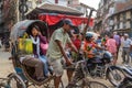 A woman rides a ricksha through Kathmandu, Nepal Royalty Free Stock Photo