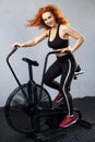 Woman riding the air bike Royalty Free Stock Photo