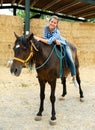 Woman riding bay horse Royalty Free Stock Photo