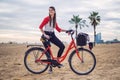 Woman riding bicycle along beach sand at summer time Royalty Free Stock Photo