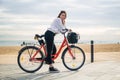 Woman riding bicycle along beach sand at summer time Royalty Free Stock Photo