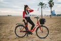 Woman riding bicycle along beach sand at summer time Royalty Free Stock Photo