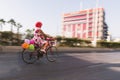 Woman riding a bicycle with baloons and fancy stuff in Izmir and on the day of Fancy Woman bike tour