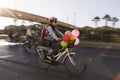 Woman riding a bicycle with baloons and fancy stuff in Izmir and on the day of Fancy Woman bike tour