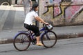 Woman riding a bicycle in Bangkok, Thailand